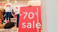 Sale up to 70 percent red sign. Red display with sale up to seventy percent inscription sticked on the store window.Seasonal dis