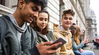 Teenagers students using smartphone on a school break