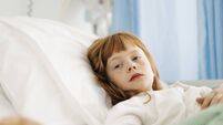 Thoughtful girl resting on bed in hospital