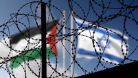 Flags of Israel and Palestine behind the barbed wire