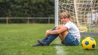 Candid Portrait of Young Girl Footballer Sitting on Field