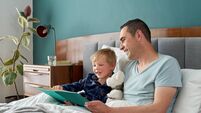 Happy father reading stories with child