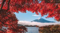 Autumn Season and Mountain Fuji with morning fog and red leaves at lake Kawaguchiko