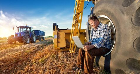 Farmer counts yields on a computer