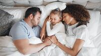 Top view, family and parents with child in bed for bonding, healthy relationship and sleeping at home. Morning, love and above o
