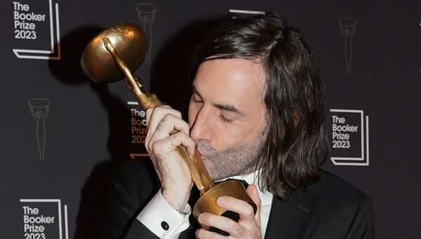 Paul Lynch kisses the trophy after being named as the winner of the 2023 Booker Prize.
