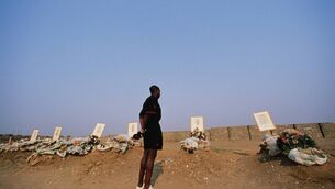 <p>RESPECT: Zambia team captain Kalusha Bwalya pays his respects to the graves of the Zambian national football team members killed in an air crash in April 1993 in Heroes Acre outside the Independence Stadium in Lusaka, Zambia. Pic: by Simon Bruty/Getty Images</p>