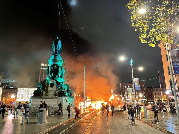 A bus and car on fire on O'Connell Street in Dublin city centre.