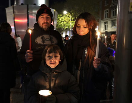 Anthony Herbert, Lisa Murry, and Zayb Murry of Gaelscoil Choláiste Mhuire at the candlelit vigil. Picture: Conor Ó Mearáin/Collins Photo Agency