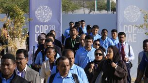 People walk through the venue at the COP28 U.N. Climate (AP Photo/Rafiq Maqbool)