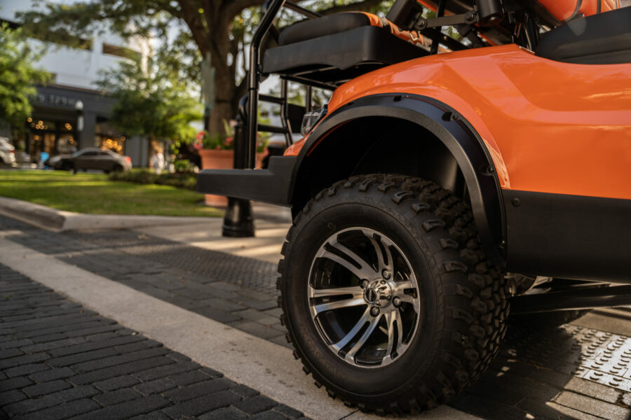 wheel of an orange golf cart